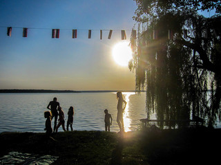 silhouettes of children playing at sunset