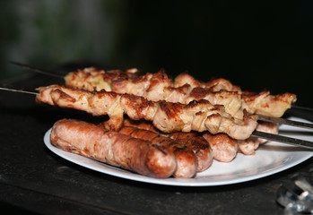 Shish kebab roasting on the grill. Cooking meat on the fire.