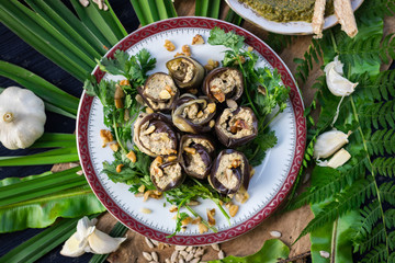 Roasted eggplant rolls with walnuts, garlic, coriander, oil, onion. Traditional Georgian food cold snack. Rolls for dinner or lunch. Raw vegan vegetarian healthy food