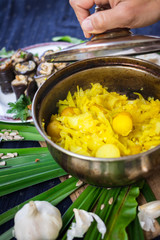 Cooked stewed cabbage with new potato in pot with garlic and turmeric powder. Lunch or dinner time. Traditional Ukrainian and Russian dish. Raw vegan vegetarian healthy food
