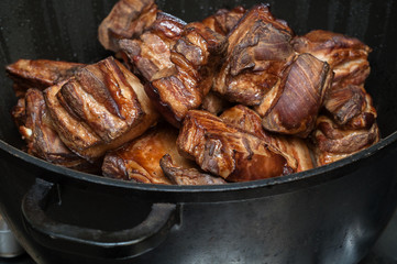 smoked meat in a cauldron