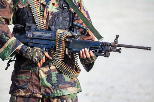 soldier in uniform with machine gun or assault rifle