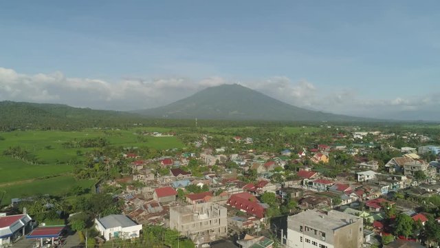 Aerial view of town in a mountain valley at the foot of the mountain Iriga. Luzon, Philippines. Mountainous tropical landscape.