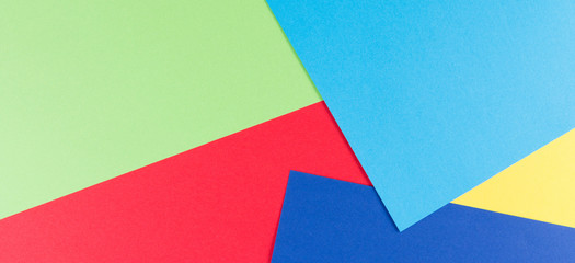 Color papers background with yellow, green, red and blue tones