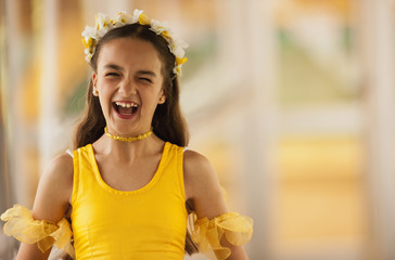 Portrait of laughing tween girl wearing ballet costume.
