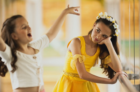 Girl sulking as she watches her sister dance.