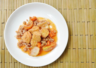 deep fried egg tofu with minced pork in sweet and sour gravy sauce on white plate