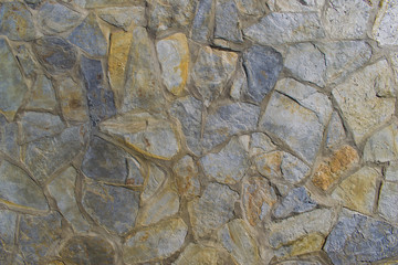 Rough grey and beige stone wall cell texture. Background. Interior design.