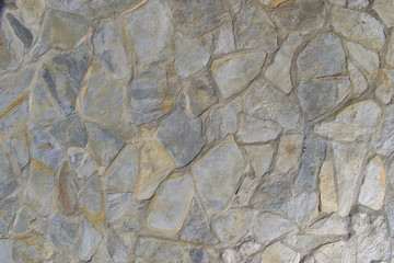 Grey stone wall background. Mosaic stone texture.