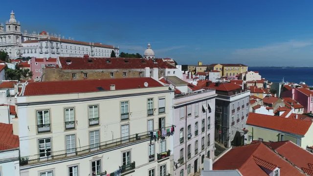 Low altitude urban aerial footage of Lisbon Portugal showing the typical white buildings and als showing Igreja da Sao Vicente de Fora and Igreja de Santa Engracia in background 4k high resolution