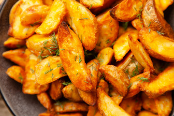 Baked potato fries on wooden table