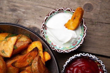Baked potato fries on wooden table