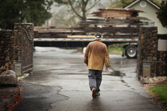 Senior man walking toward a truck.