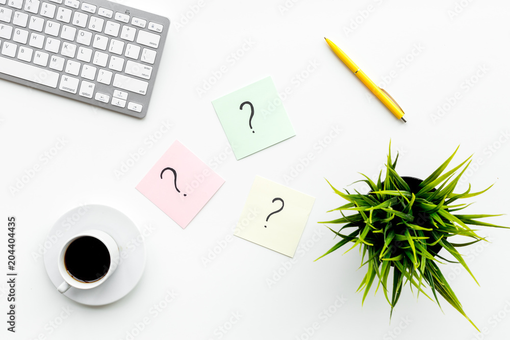 Poster question mark on sticky notes on office desk on white background top view. faq concept. working with