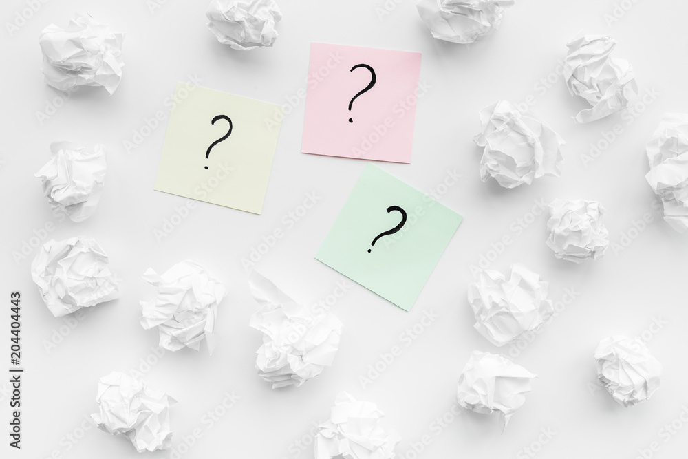 Poster faq concept. question mark on sticky notes near crumpled paper on white background top view