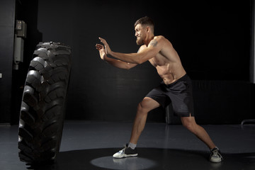 Crossfit training - man flipping tire