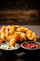 Baked potato fries on wooden table