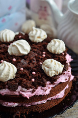 Mississippi mud cake with meringues on black plate