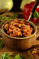 Lentil and tomato paste in a bowl on wooden background