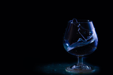 splash of water in a glass on a black background
