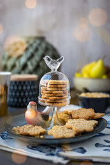 On the plate is a curly cookie with decorative patterns made with a wooden rolling pin