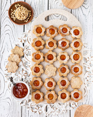 Figured biscuits in the form of chamomile, with apricot jam. On the stand