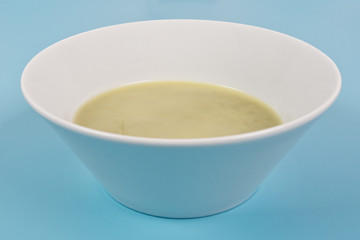 Healthy spinach soup on a blue