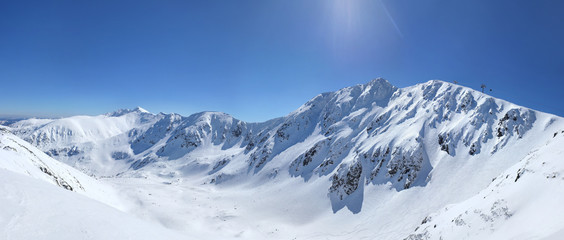 High resolution panorama of snow covered mount Chopok peak in Jasna, Low Tatras, Slovakia on a bright sunny winter day.