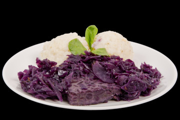 Tempeh with red cabbage and sorghum on a black