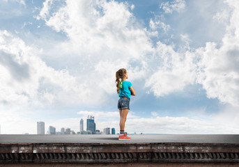 Concept of careless happy childhood with girl looking far away
