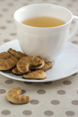 Biscuits rolls on white plate, tasty chocolate sweets for tea break