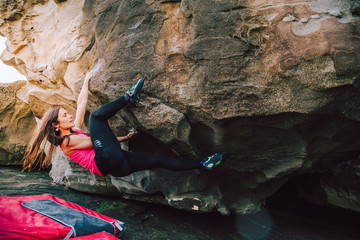 Brave young rock climber woman