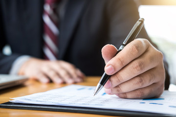 Professional businessman working, Doing finance on laptop, document graph and analysis business strategy to development profit
