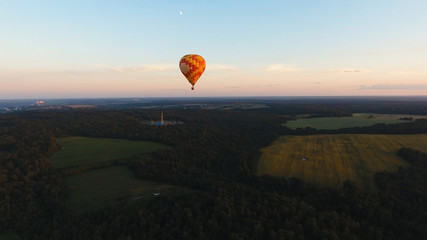 Aerial view Hot air balloon in the sky over a field in the countryside in the beautiful sky and...