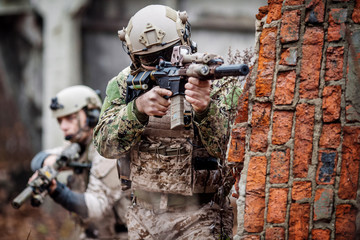 soldiers or private military contractors aiming with rifle. war, army, weapon, technology and...