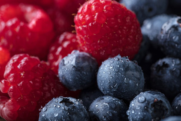  Ripe and juicy fresh blueberries and raspberries .