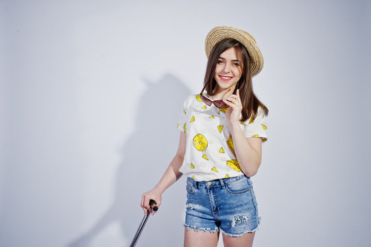 Girl tourist with bag, wear in shirt, shorts and hat with glasses isolated on white.