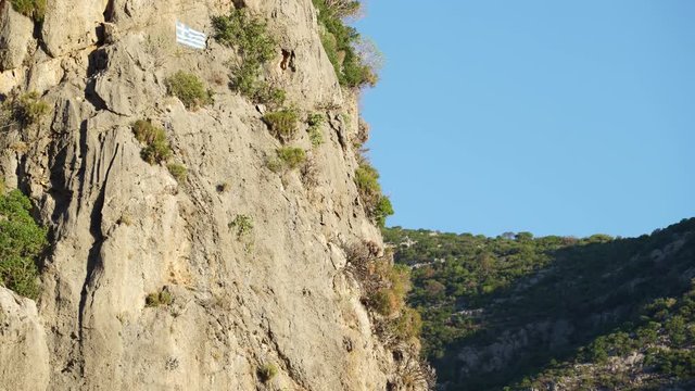 Greek flag on rock in Taygetus mountains Greece Peloponnese, Europe 4K