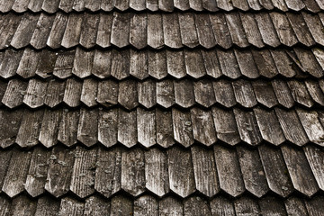 Old wood shingle roof with rough surface