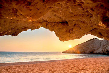 Unbeatable beautiful spectacular scenery with sunset on the Porto Katsiki Beach on the island of Lefkada, Greece. View from the cave. Amazing places. Tourist Attractions.