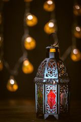 The Muslim feast of the holy month of Ramadan Kareem. Beautiful background with a shining lantern...