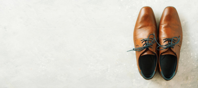 Top view of fashion male shoes on gray background. Sale and shopping concept. Copy space.