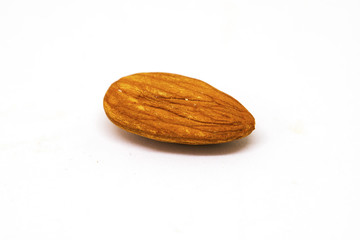 Almond nut isolated on white background. Single dry nut closeup photo. Simple organic food.