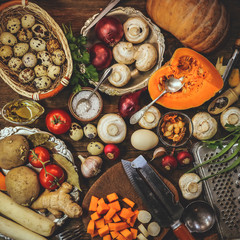 cooking dishes from pumpkin and mushrooms champignons. spices and ingredients. vintage kitchen appliances. healthy food. wooden background.