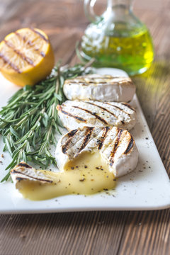 Grilled Camembert cheese with olive oil and rosemary