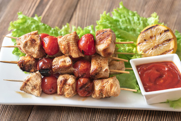 Grilled chicken skewers on the white plate