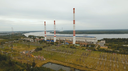 Fototapeta na wymiar Aerial view Hydroelectric power station, transformation station, cables and wires. High voltage electric power substation. Electrical power transformer in high voltage substation.