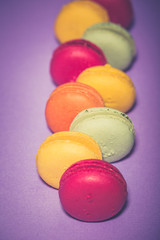 Close up colorful macarons dessert with vintage pastel tones