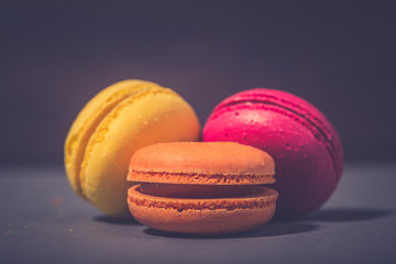 Close up colorful macarons dessert with vintage pastel tones