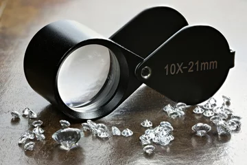 Gardinen brilliant cut diamonds with folding magnifier on wooden background © Björn Wylezich